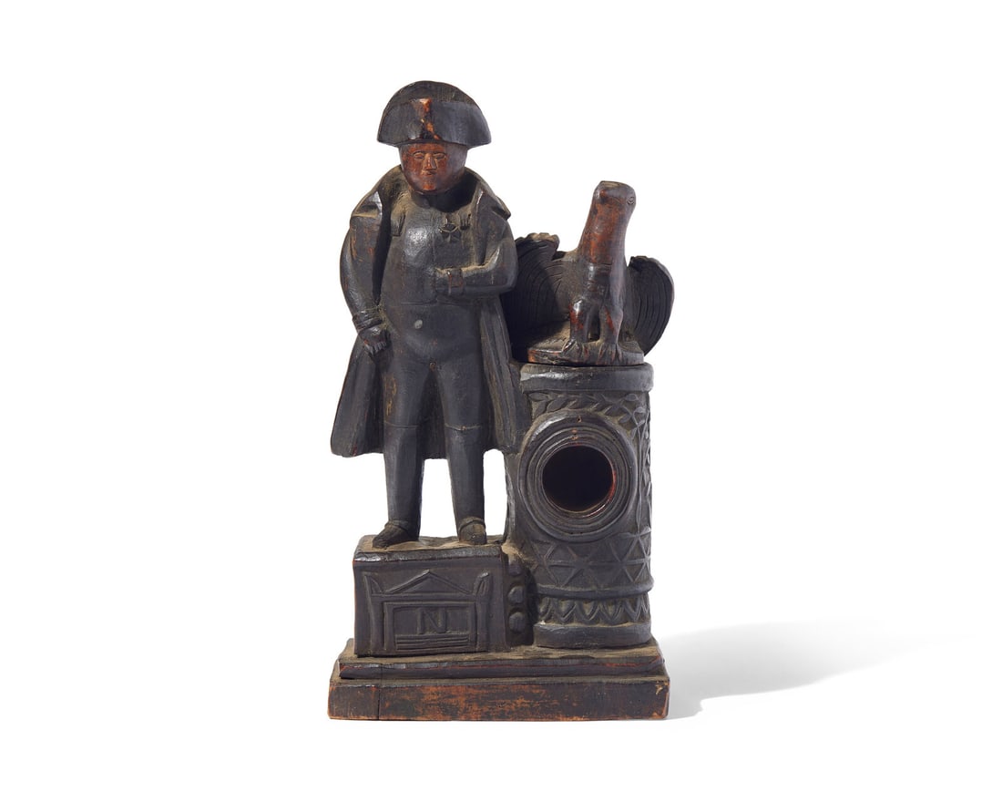 A Carved Wood Watch Hutch in the Form of Napoleon with Eagle: A Carved Wood Watch Hutch in the Form of Napoleon with Eagle Dated, "1820" raised on carved platform, Napoleon is depicted standing on a pedestal carved with monument bearing monogram, "N", the eagle