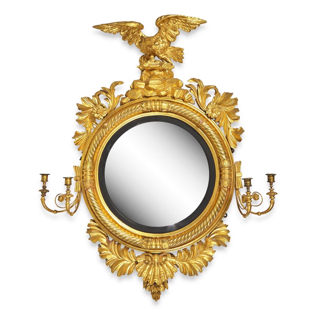 A Large Classical Giltwood Bull's Eye Girandole Mirror: A Large Classical Giltwood Bull's Eye Girandole Mirror First Quarter 19th Century surmounted by eagle, with leafage and shell, each side with two candle arms. Height 52 x width 41 1/2 x depth 9 inches