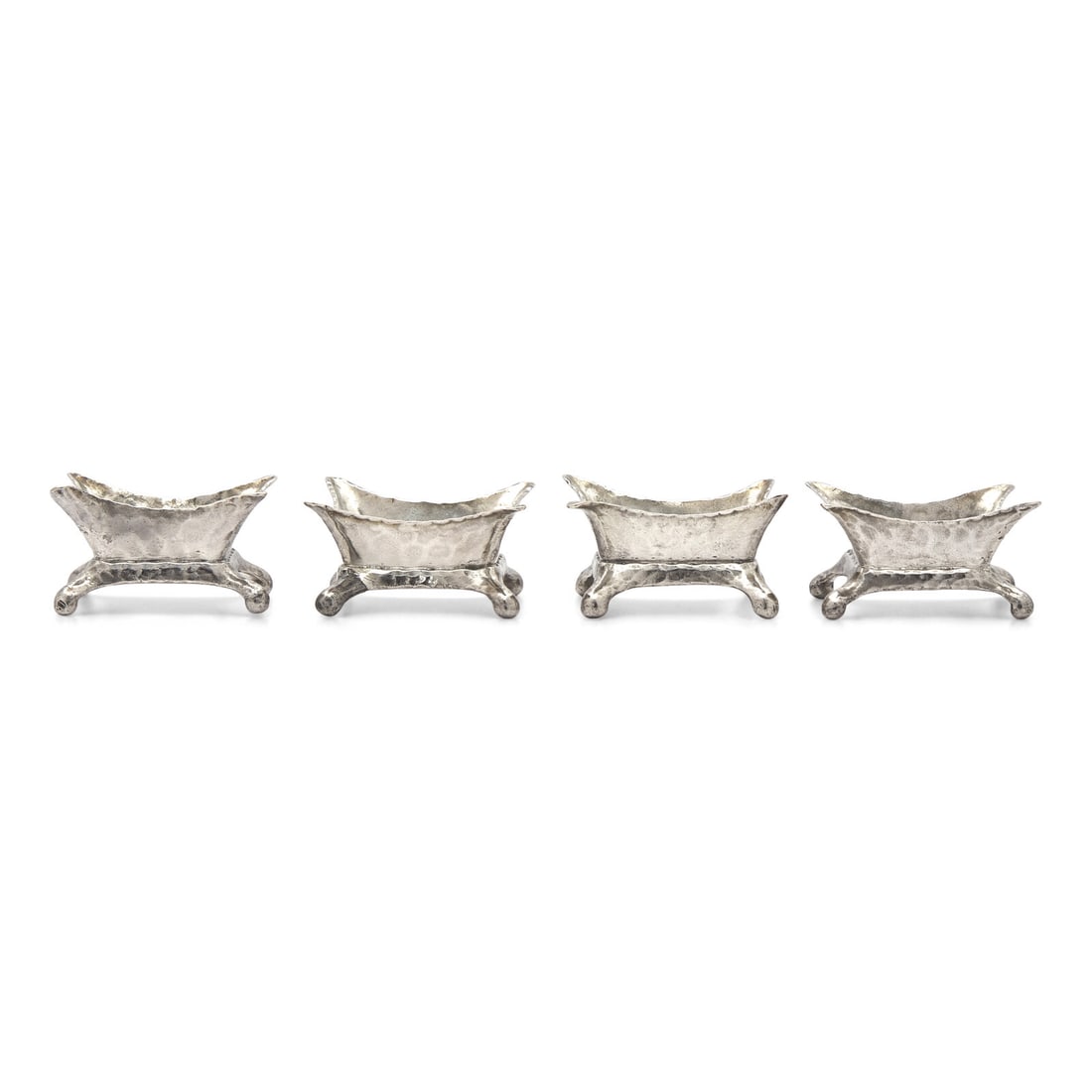 A Set of Four Aesthetic Movement Hammered Sterling Silver Salt Cellars: A Set of Four Aesthetic Movement Hammered Sterling Silver Salt Cellars Tiffany and Co., New York, New York, Circa 1880-1890 marked to underside, including "M" mark indicating directorship of Edward Mo