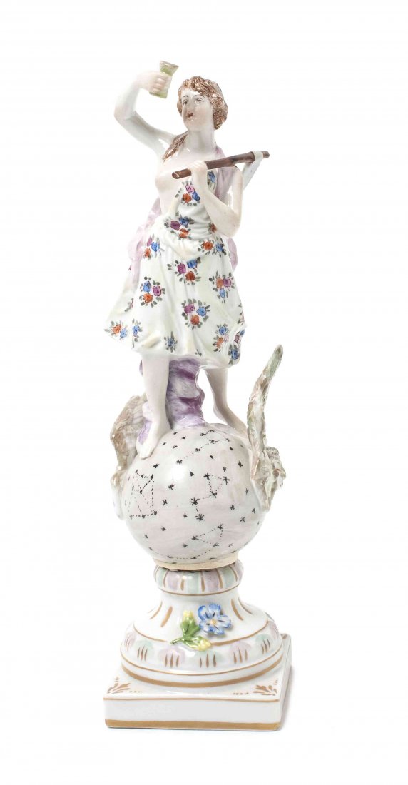 A German Porcelain Figure, Carl Thieme, Height 9 1/2 in: A German Porcelain Figure, Carl Thieme, depicting a female figure atop a winged globe, raised on a square base. Height 9 1/2 inches. Property from the Collection of Charles Scofield, Evergreen, Colora