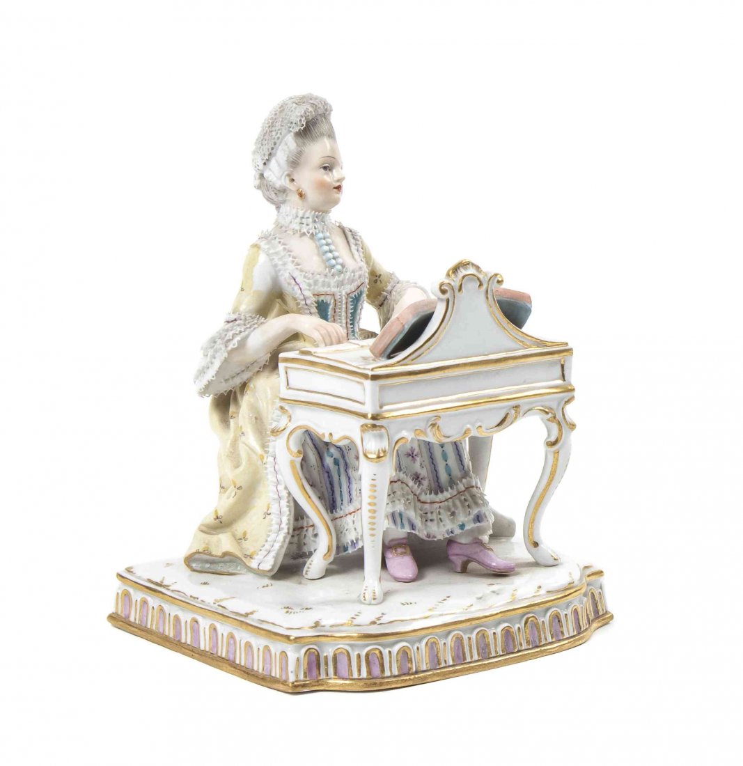 A Meissen Porcelain Figure, Height 4 3/4 inches.: A Meissen Porcelain Figure, depicting a woman in 18th century attire playing an organ, raised on a stylized base, having crossed swords in blue underglaze, incised E.P., impressed 43. Height 4 3/4 inc