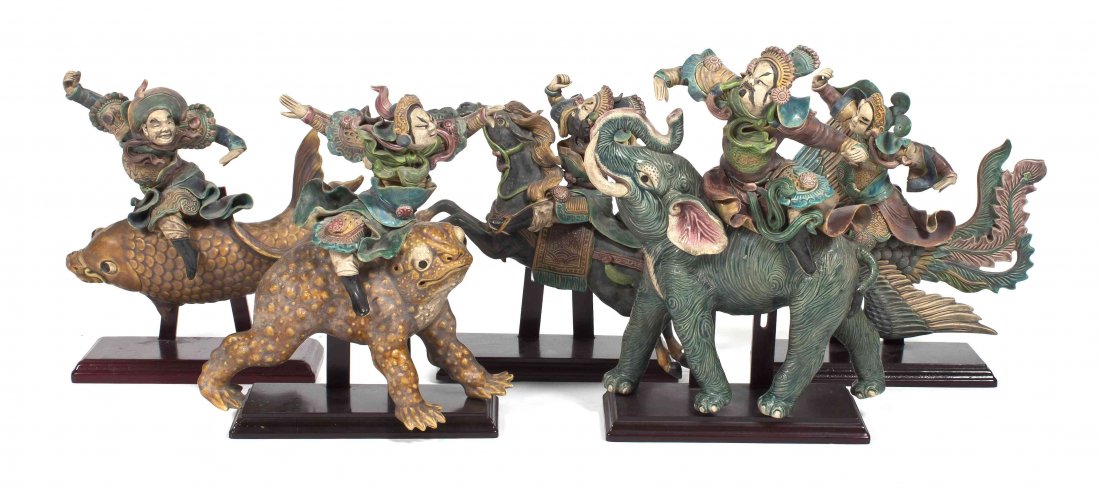 A Set of Ten Chinese Polychrome Painted Ceramic Roof Ti: A Set of Ten Chinese Polychrome Painted Ceramic Roof Tile Figures, each depicting a guardian figure riding a beast including a horse, carp, toad, elephant and qilin, each raised on a stand. Height of 