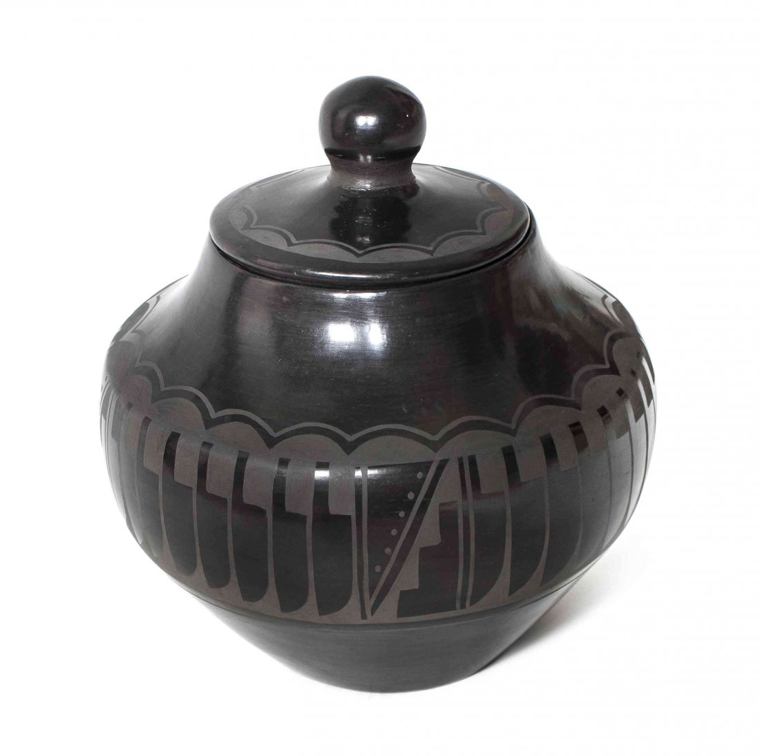 A San Ildefonso Black on Black Lidded Jar, Carlos Sunri: A San Ildefonso Black on Black Lidded Jar, Carlos Sunrise Dunlap and Carmalita Dunlap, having concave base and high rounded shoulder, the lid with knob having scalloped decoration above shoulder with