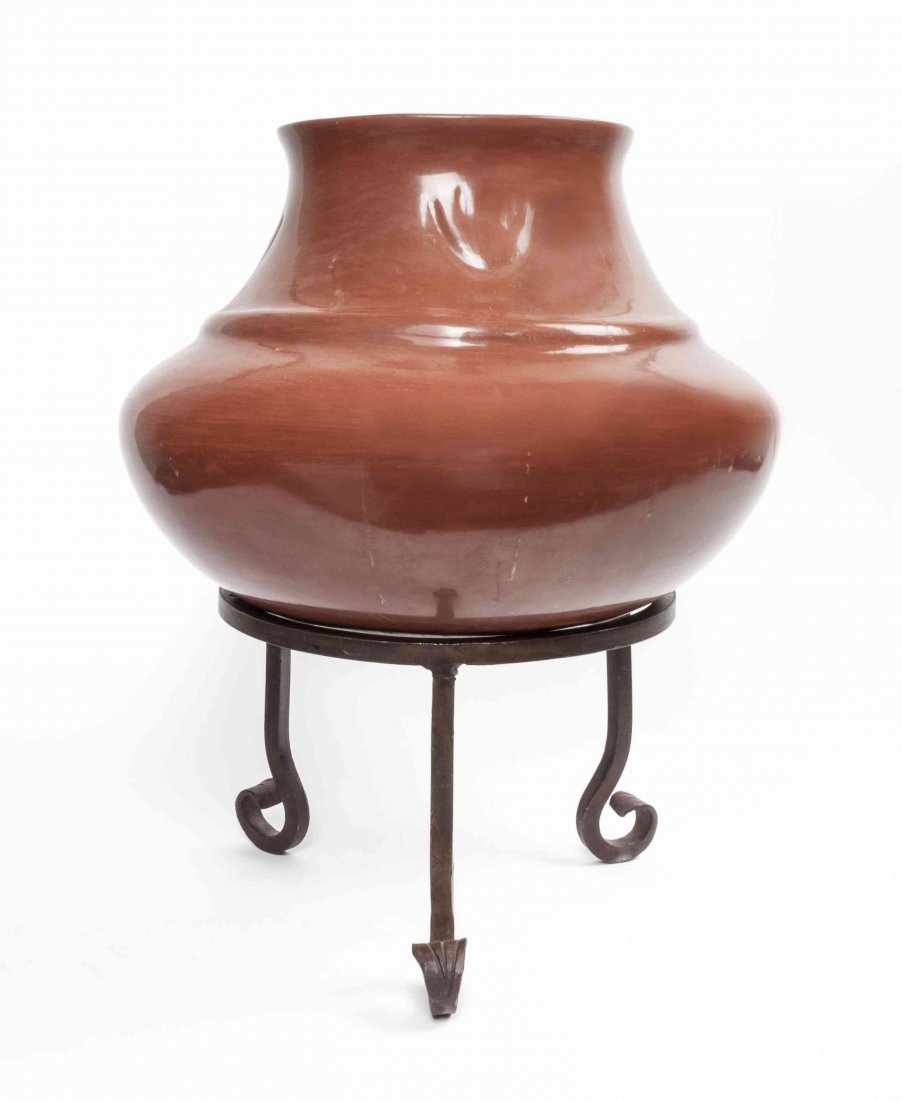 A Santa Clara Redware Water Jar, Margaret Tafoya, Heigh: A Santa Clara Redware Water Jar, Margaret Tafoya, having concentric bowls emerging to a tall neck and flaring rim, decorated with four bear paw impressions encirclling the shoulder, signed Margaret Ta