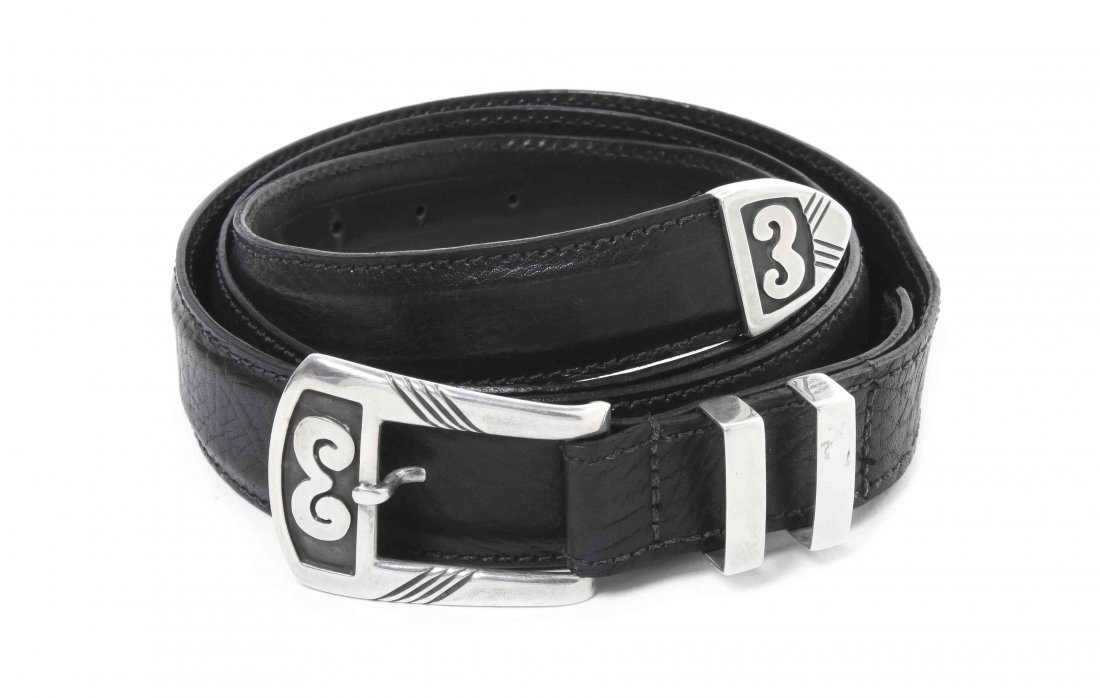A Navajo Sterling Silver Ranger Set, Allen Kee, from Wh: A Navajo Sterling Silver Ranger Set, Allen Kee, from White Hogan, having rams horn design on buckle and tip with straight line accents and plain silver keepers, marked on buckle, symbol for the artist
