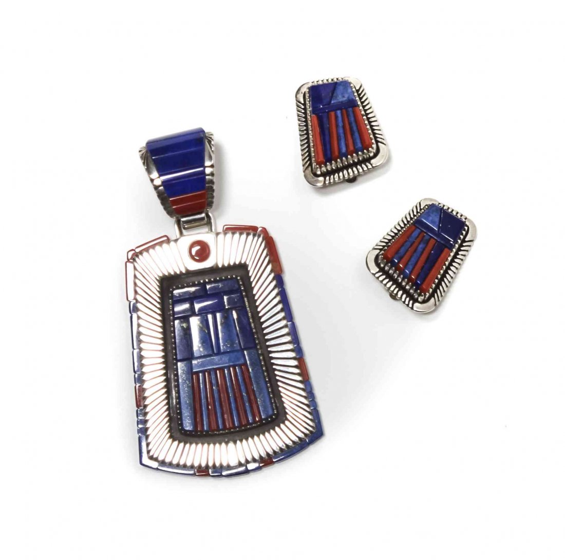 A Kiowa Sterling Silver, Lapis, and Coral Pendant, Byro: A Kiowa Sterling Silver, Lapis, and Coral Pendant, Byron McCurtain, together with matching ear clips, the pendant with elongated trapezoidal form having segmented border surrounding a lapis and coral 