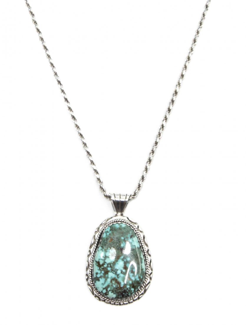 A Southwestern Sterling Silver and Turquoise Pendant, H: A Southwestern Sterling Silver and Turquoise Pendant, with tooled silver bezel surrounding a tear drop turquoise stone, marked JB with tipped J, suspended on a commercial Italian twisted link chain, m
