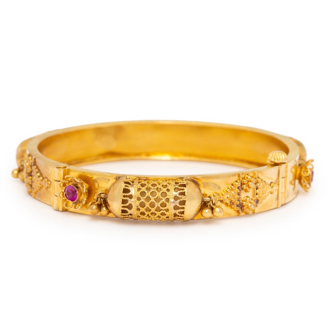 High Karat Yellow Gold and Synthetic Ruby Bangle Bracelet: High Karat Yellow Gold and Synthetic Ruby Bangle Bracelet Round synthetic rubies, hinged with side clasp. High karat yellow gold. 7 inches inner circumference. Gross weight: 15.30 dwt. Kashyap Estate