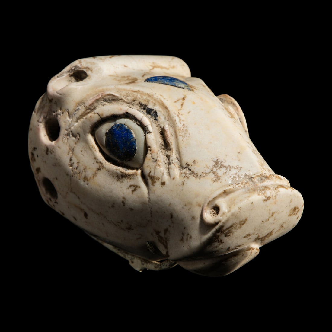 A Mesopotamian Marble and Lapis Lazuli Inlay Bull Head: A Mesopotamian Marble and Lapis Lazuli Inlay Bull Head Late Uruk-Jemdat Nasr Period, Circa 3300-2900 B.C. Length 9 cm (3 1/2 inches). Provenance: Private Collection, United States, acquired in 1981.
