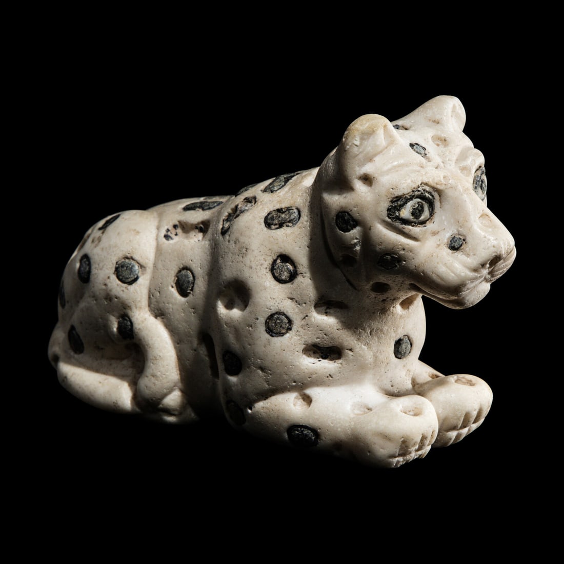 A Mesopotamian Marble and Lapis Lazuli Recumbent Leopard: A Mesopotamian Marble and Lapis Lazuli Recumbent Leopard Late Uruk-Jemdat Nasr Period, Circa 3300-2900 B.C. Length 11.5 cm (4 1/2 inches). Provenance: Art Market, United Kingdom. Private Collection (M