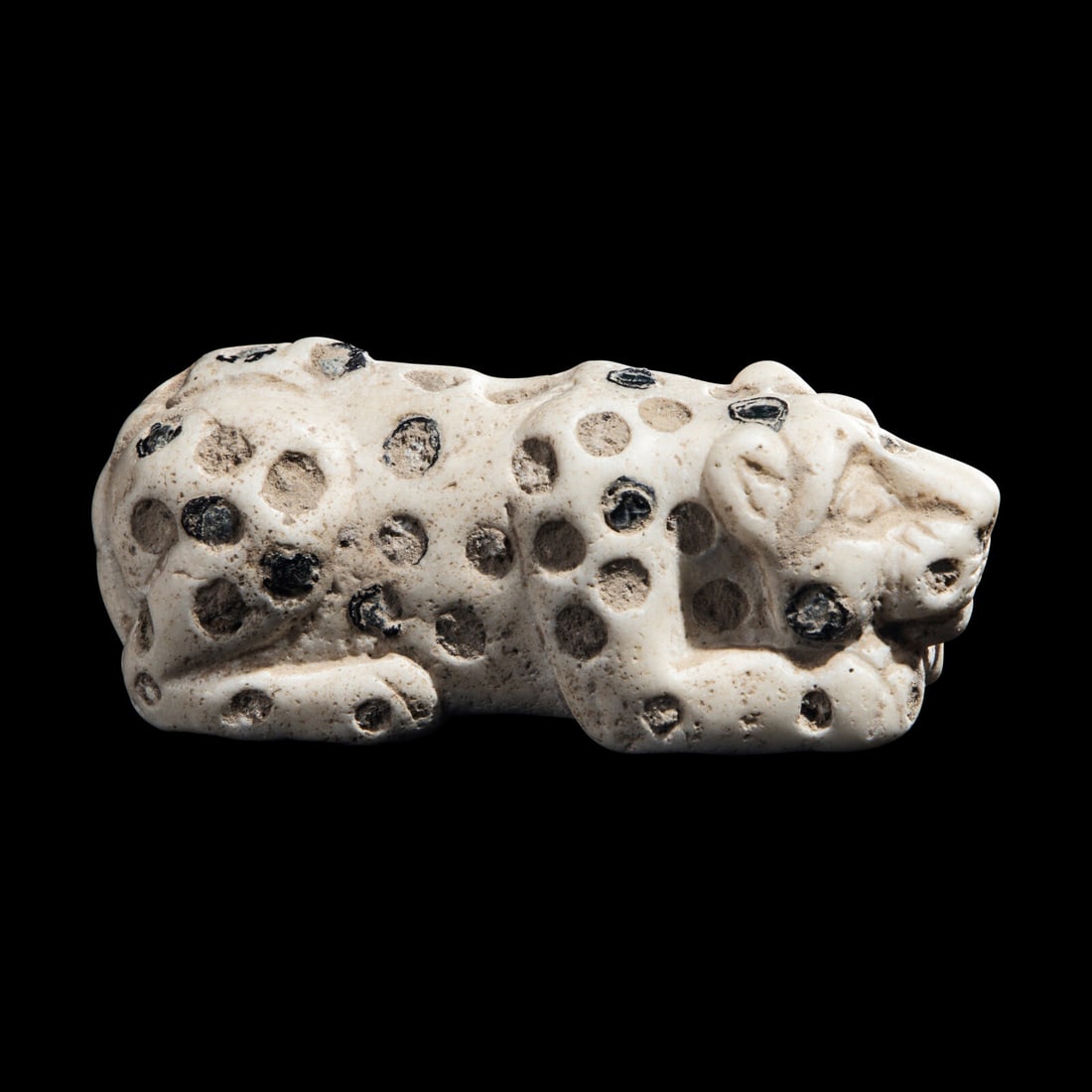 A Mesopotamian Marble and Lapis Lazuli Inlay Recumbent Feline: A Mesopotamian Marble and Lapis Lazuli Inlay Recumbent Feline Late Uruk-Jemdat Nasr Period, Circa 3300-2900 B.C. Length 7 cm (2 3/4 inches). Provenance: Private Collection, United States, acquired in 