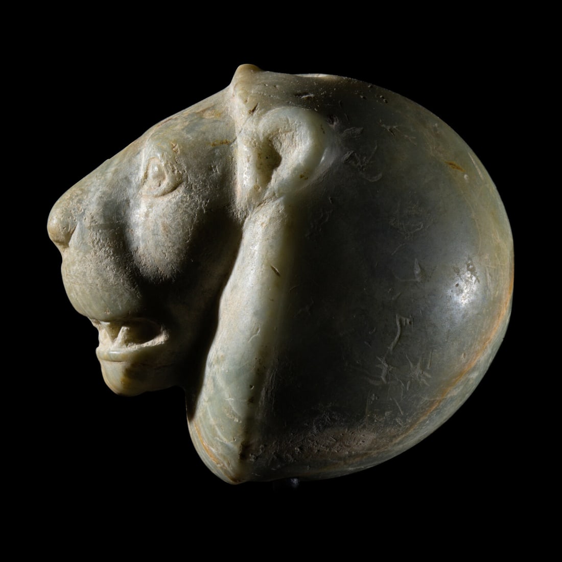 A Mesopotamian Green Stone Seal with a Lion Head: A Mesopotamian Green Stone Seal with a Lion Head Late Uruk-Jemdet Nasr Period, Circa 3500-2900 B.C. Length 6 cm (2 3/8 inches). Property from a Pacific Northwest Collection Provenance: Private Collect