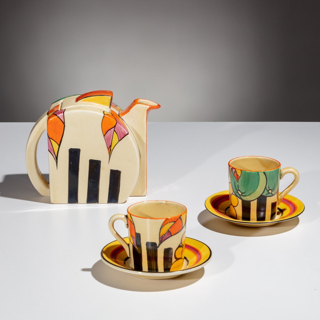 Clarice Cliff (English, 1899–1972) Apples pattern Teapot and Two Cups w/ saucers, 5 pieces: Clarice Cliff (English, 1899–1972) Apples pattern Teapot and Two Cups w/ saucers, 5 pieces each piece stamped 'Clarice Cliff' to underside hand-glazed earthenware 4 ¾ h × 5 ½ w &#
