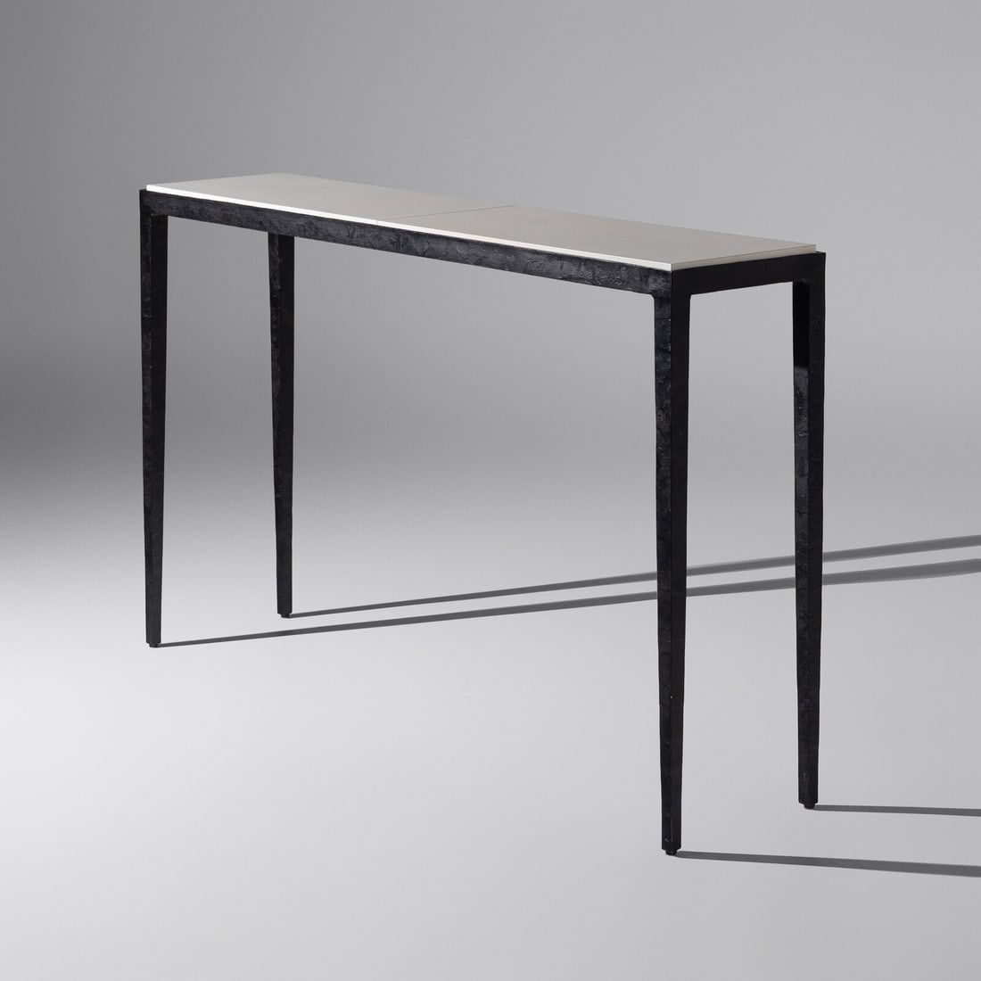 Christian Liaigre (French, 1943–2020) Console Table for Holly Hunt: Christian Liaigre (French, 1943–2020) Console Table for Holly Hunt hammered steel, parchment 32 h × 52 w × 12 d in. This lot is located in Chicago.
