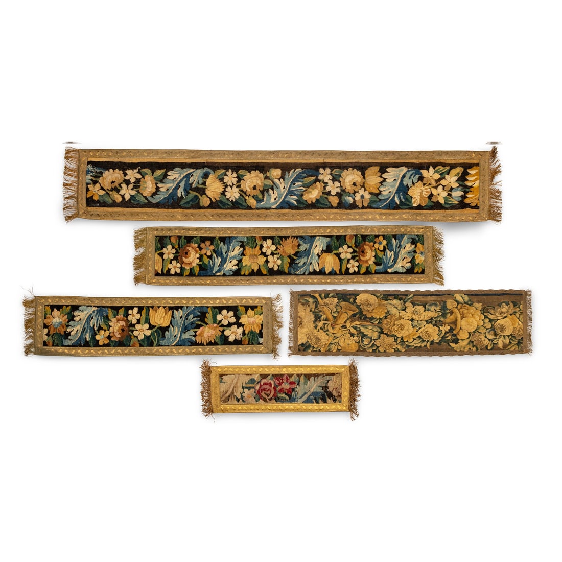 A Group of Five Flemish Tapestry Panels: A Group of Five Flemish Tapestry Panels 17th/18th Century each cut down and set within a gilt fabric border. Length of largest 72 x width 12 inches. Property from the Collection of Robert and Roseann