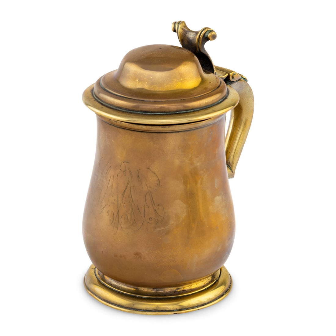 A George I Brass Covered Tankard: A George I Brass Covered Tankard Circa 1720 the underside and interior showing traces of original silvering and having pseudo-marks below the lip of body, the handle and body with engraved monograms.