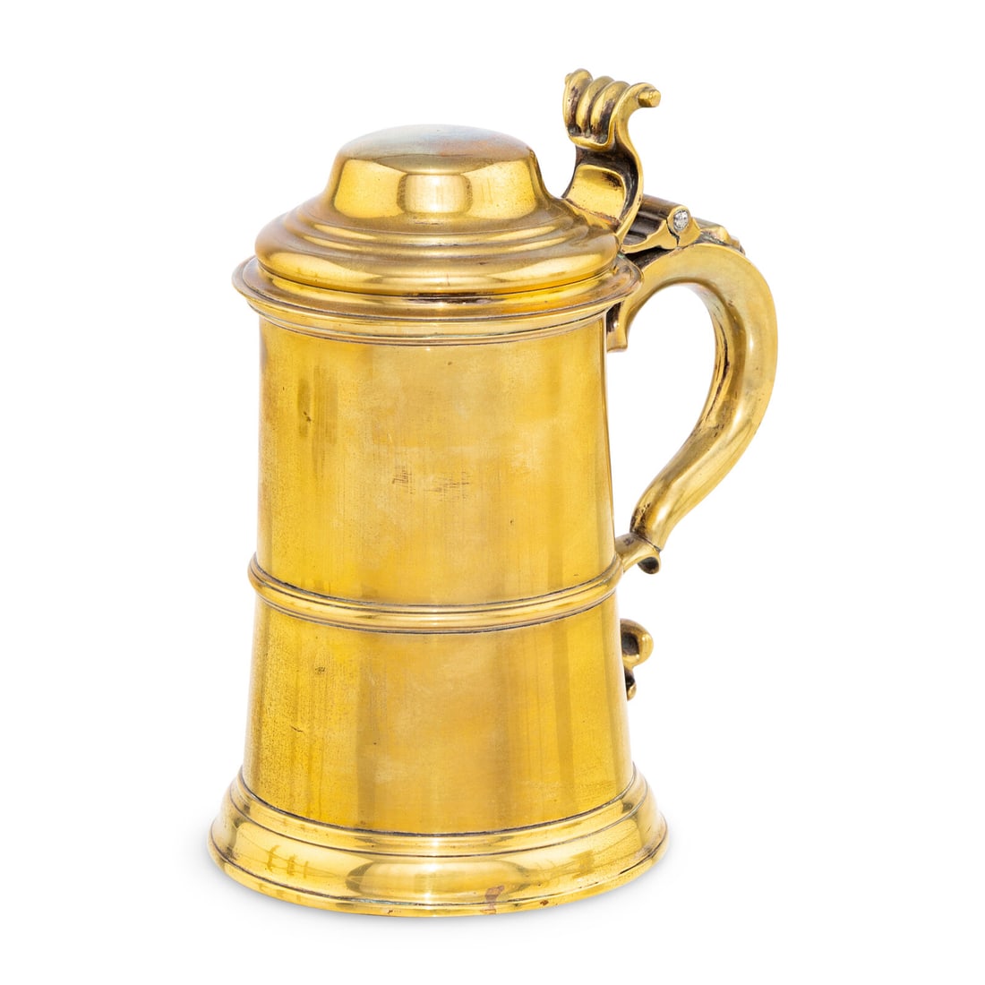 A George II Brass Covered Tankard: A George II Brass Covered Tankard Circa 1730 the underside and interior showing traces of original silvering and having pseudo-marks below lip of body. Height 7 3/4 inches. Property from the