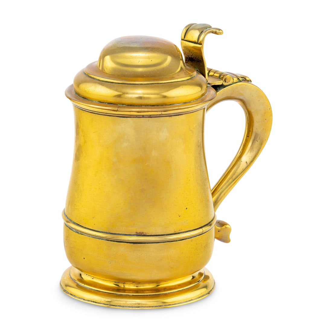A George II Brass Covered Tankard: A George II Brass Covered Tankard First Half 18th Century the domed lid surmounting a baluster-form body with pseudo-marks beneath lip rim and raised on a circular foot. Height 7 1/4 x width 6 1/2