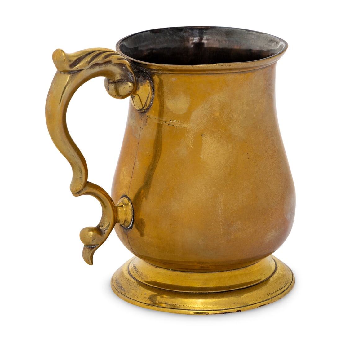 An English Brass Pint Tankard: An English Brass Pint Tankard Mid 18th Century the underside retaining traces of original silvering decoration. Height 5 x width 5 1/2 inches. Property from the Collection of Robert and Roseann
