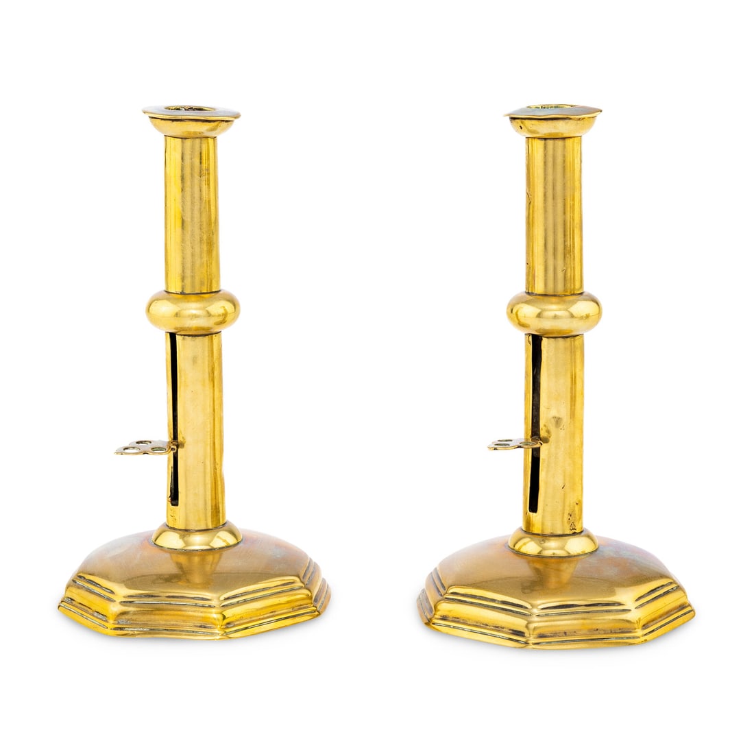 A Rare Pare of English Brass Candlesticks: A Rare Pare of English Brass Candlesticks Circa 1690 the stems with a central knop and each having a pierce-decorated candle ejector and raised on a stepped octagonal base. Height 10 1/2 inches.