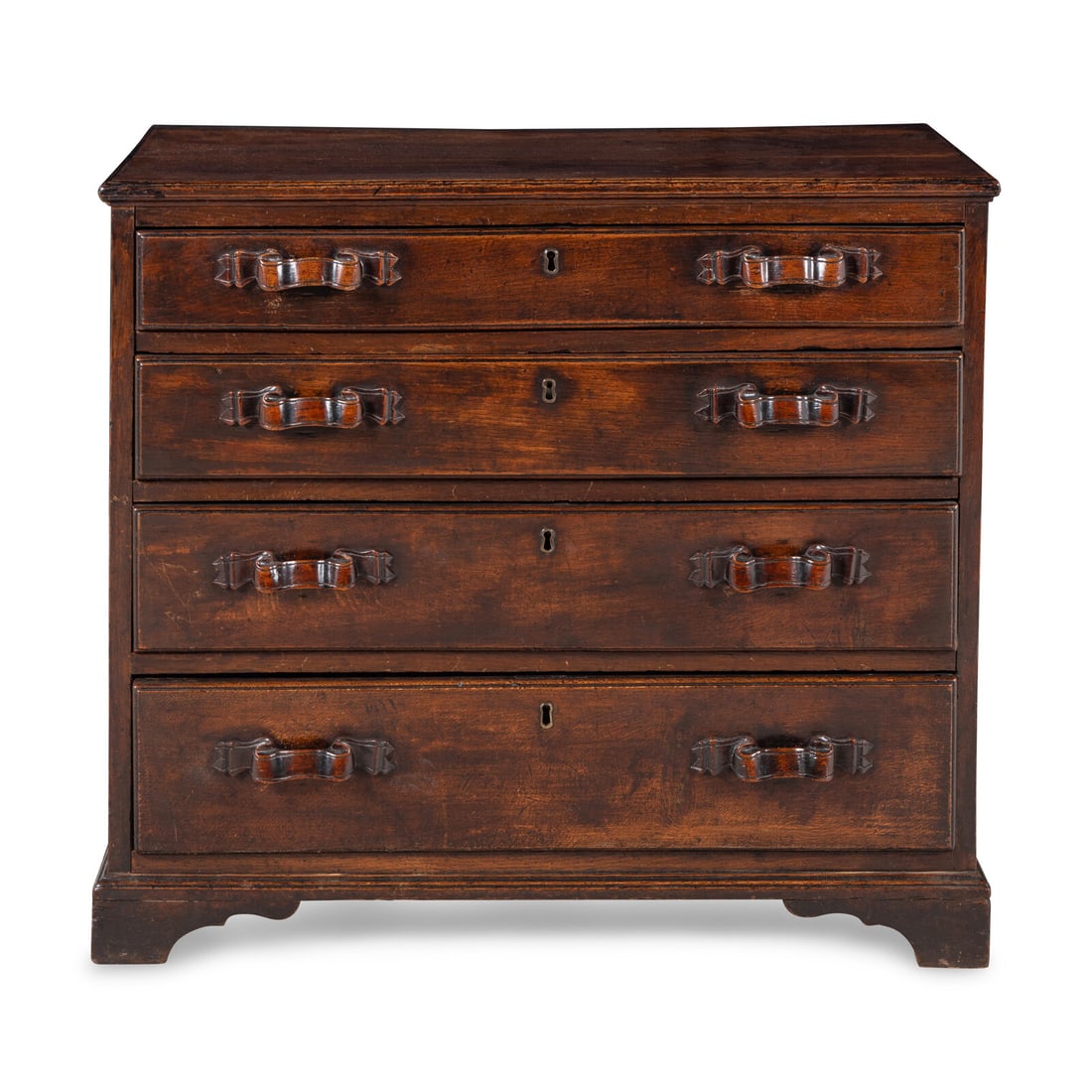 An English Oak Chest of Drawers: An English Oak Chest of Drawers Mid 18th Century the handles in the form of carved ribbons. Height 31 1/4 x width 35 x depth 18 1/4 inches. Property from the Collection of Robert and Roseann Drucker, 