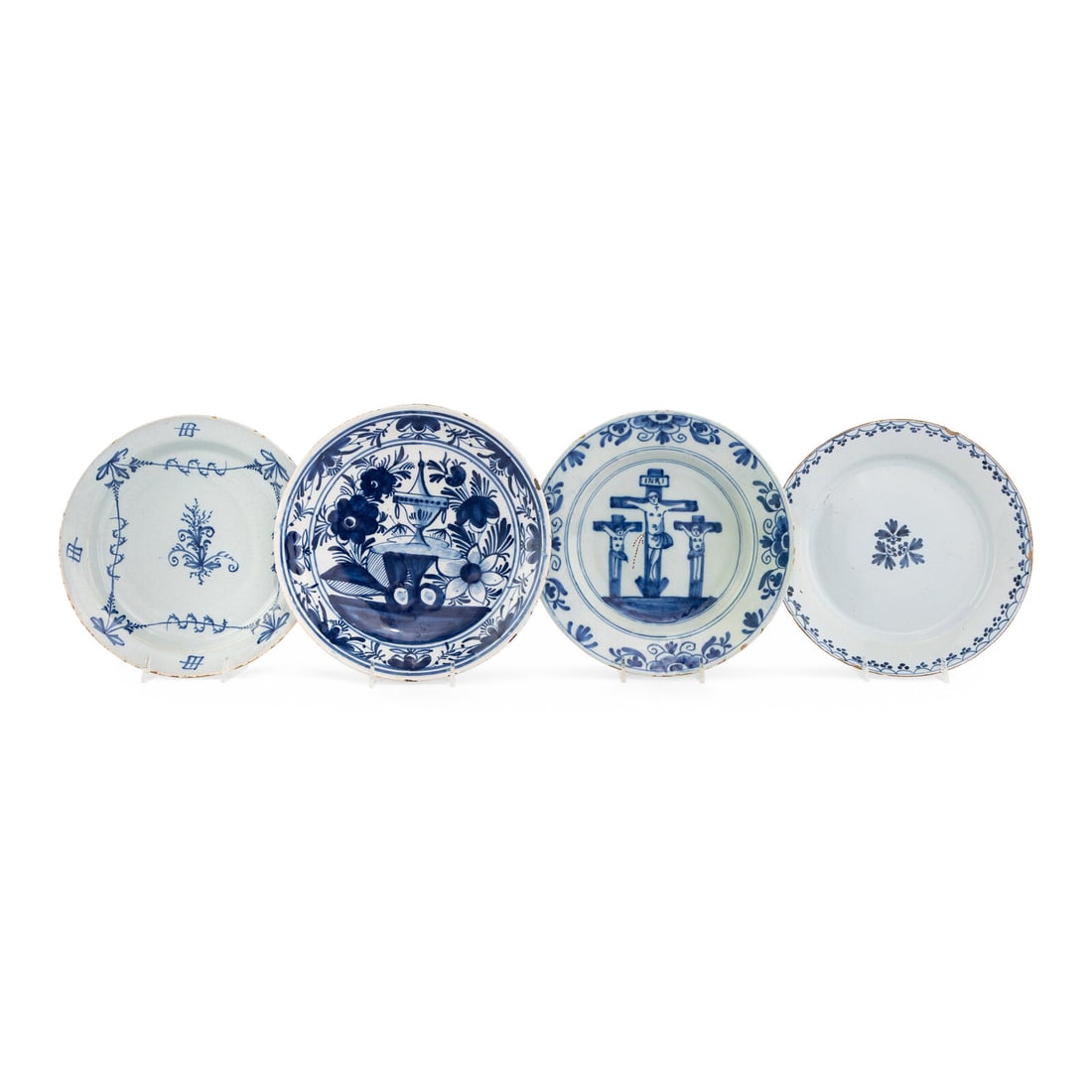 A Collection of Four Dutch Delft Blue and White Articles: A Collection of Four Dutch Delft Blue and White Articles 18th Century one example decorated with a scene of the crucifixion, together with three other examples with foliate decoration. Diameter of