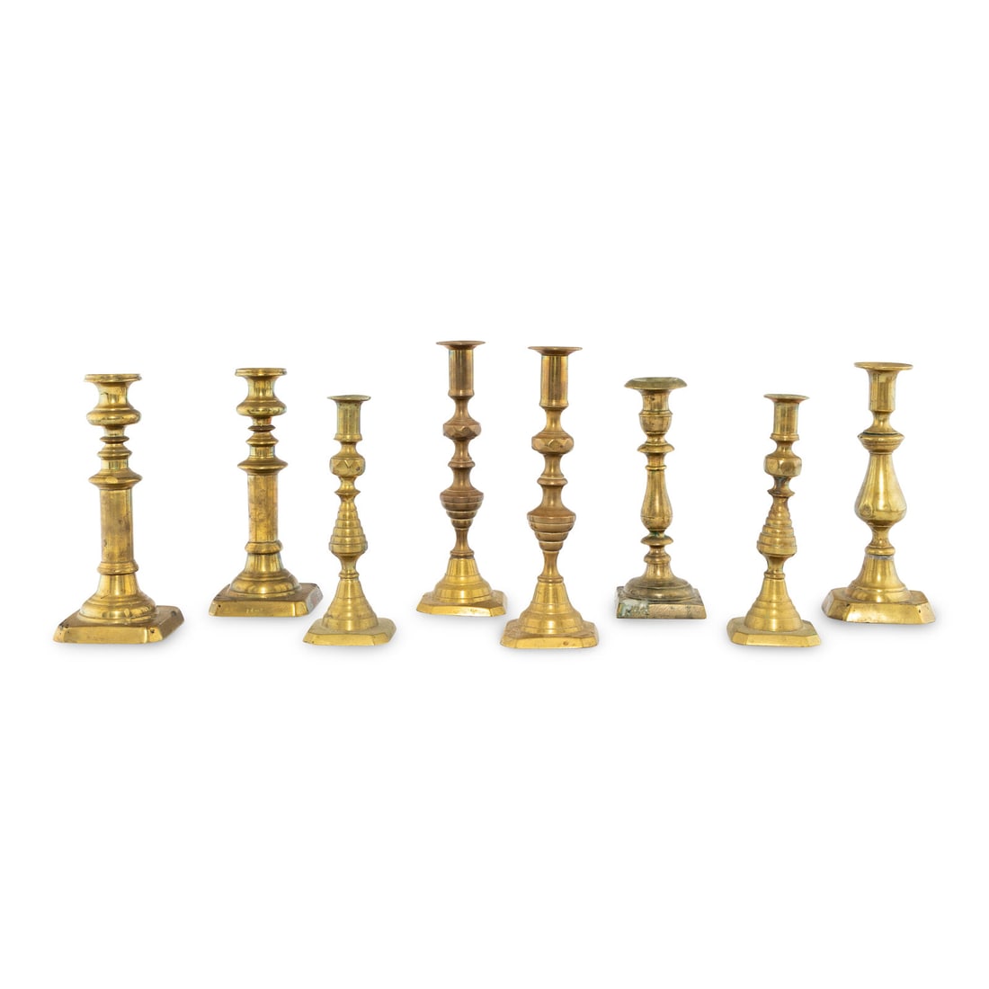 A Collection of Eight Continental Brass Candlesticks (1 of 2)