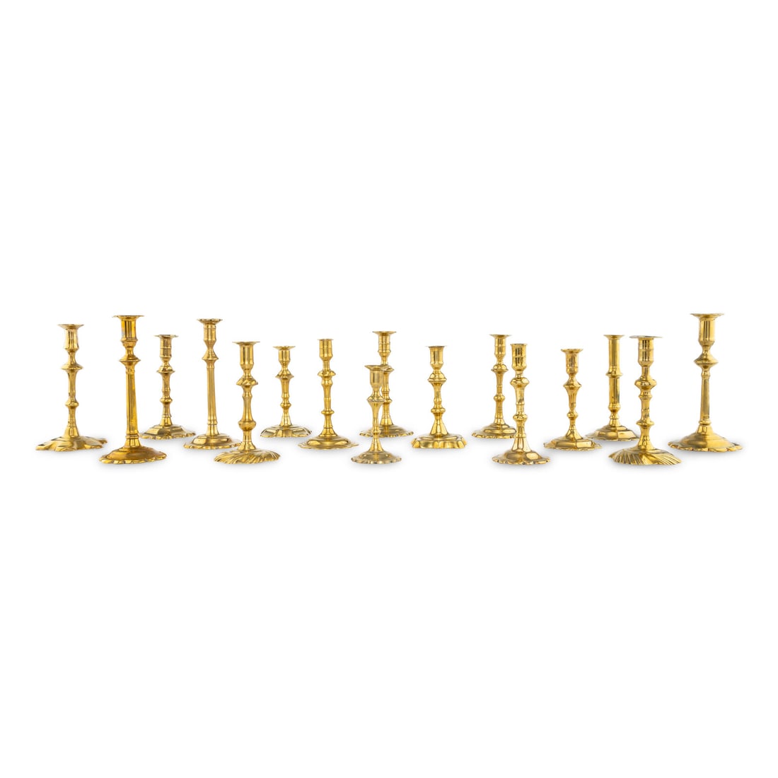 A Group of Sixteen Brass Candlesticks: A Group of Sixteen Brass Candlesticks Most 18th Century each having a knopped stem above a scalloped base. Height of tallest 9 3/4 inches. This lot is located in Chicago.
