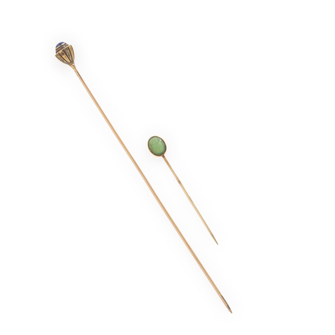 Two Yellow Gold Stick Pins: Two Yellow Gold Stick Pins Including two stick pins, one with a round cabochon lapis lazuli measuring approximately 5.65 mm, and one with a carved emerald scarab measuring approximately 7.75 x 9.70
