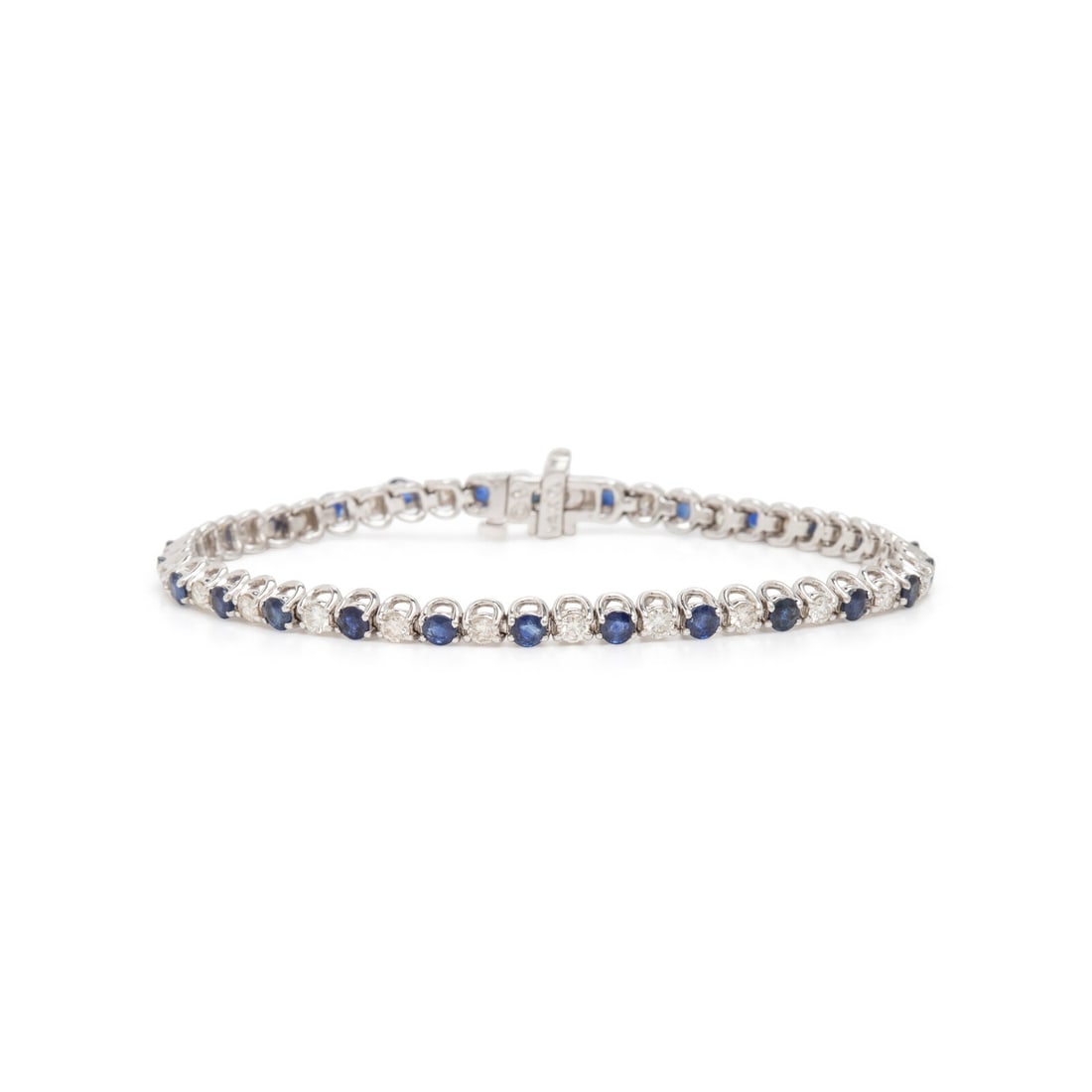 Sapphire and Diamond Bracelet: Sapphire and Diamond Bracelet Round diamonds weighing approximately 1.35 carats total, and round sapphires. 14 karat white gold. 7 1/16 inches long. Stamp: 14K (maker's marks). Gross weight: 7.70