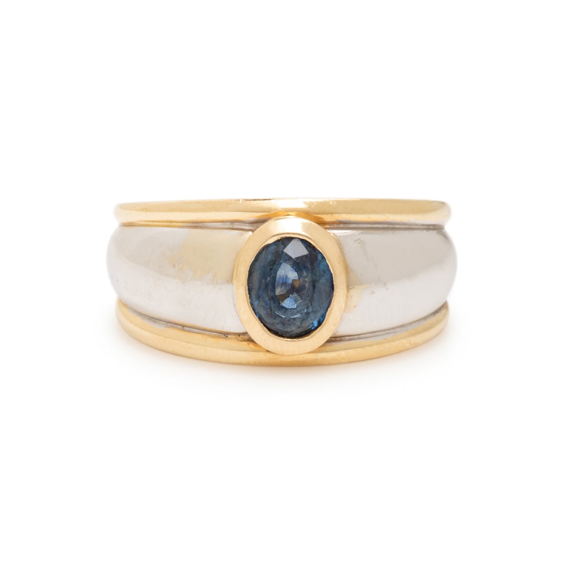 Bicolor Gold and Sapphire Ring: Bicolor Gold and Sapphire Ring Oval sapphire weighing approximately 1.00 carat by formula. 14 karat white and yellow gold. Ring size 7 1/2. Stamp: (maker's mark) 14K. Gross weight: 5.30 dwt. From the