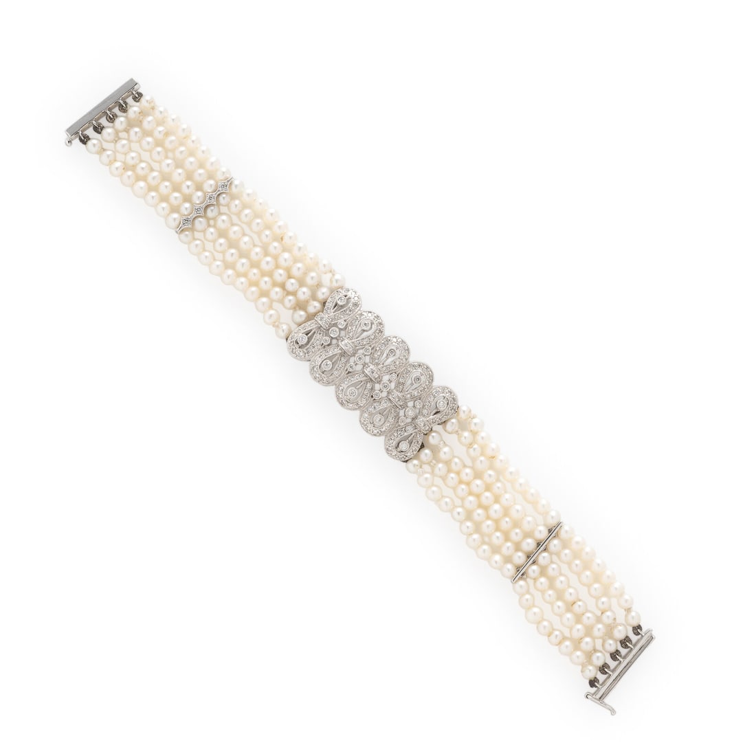 Pearl and Diamond Bracelet: Pearl and Diamond Bracelet Four strands of seed pearls and round diamonds weighing approximately 1.20 carats total. 18 karat white gold. 6 inches long. Stamp: 750. Gross weight: 12.35 dwt. From the