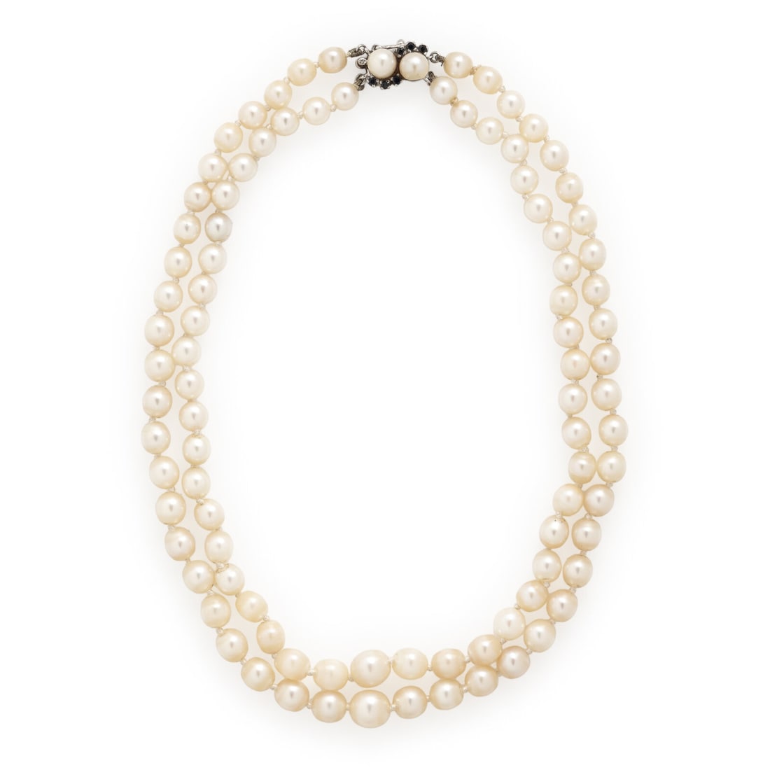 Cultured Pearl and Sapphire Necklace: Cultured Pearl and Sapphire Necklace Two strands of cultured pearls measuring approximately 5.80 - 7.80 mm, the clasp set with cultured pearls and round sapphires. 14 karat white gold. 14 1/2 inches
