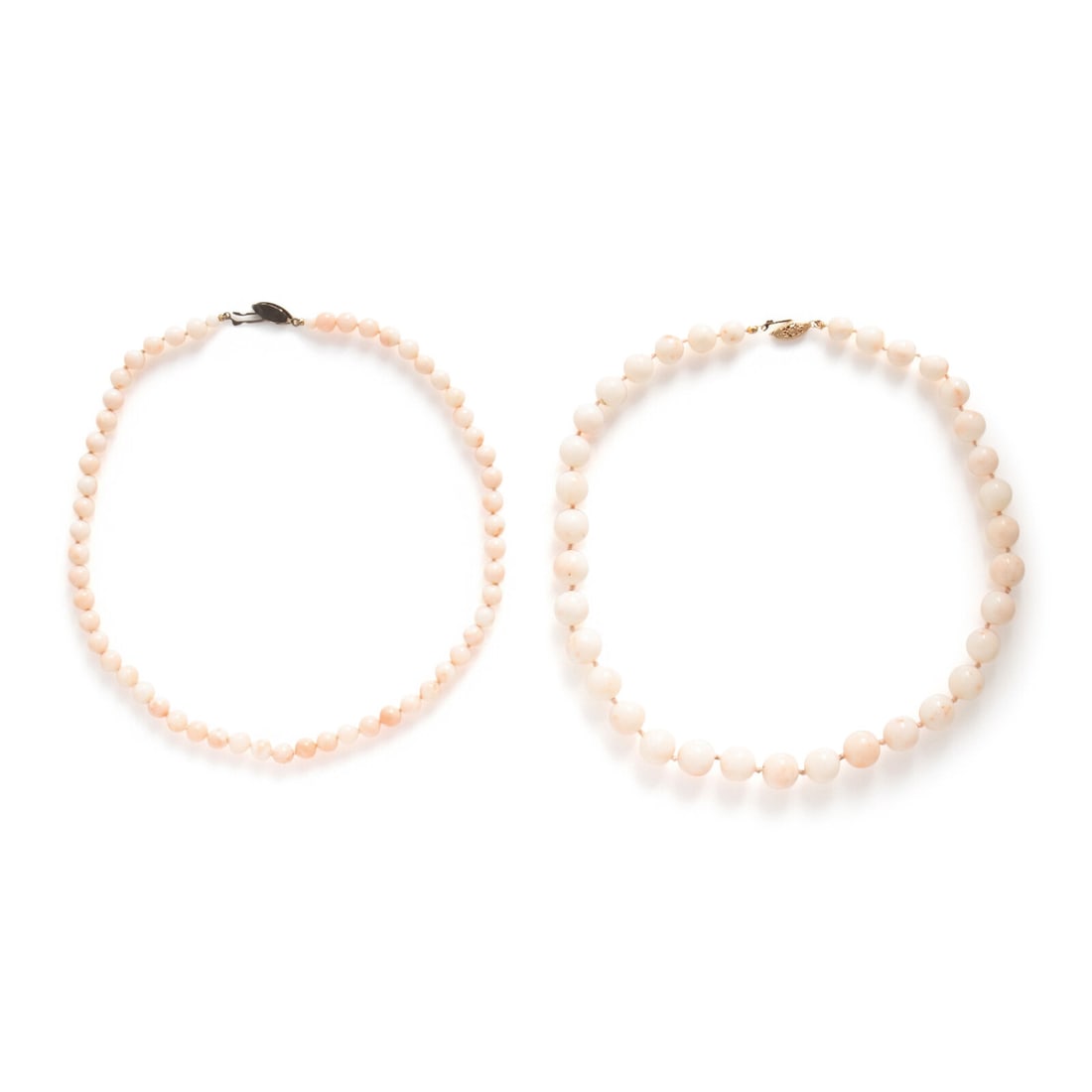 Two Coral Bead Necklaces: Two Coral Bead Necklaces Including two necklaces, one with coral beads measuring approximately 7.00 - 7.15 mm, and another with graduating coral beads measuring approximately 8.60 - 12.30 mm.