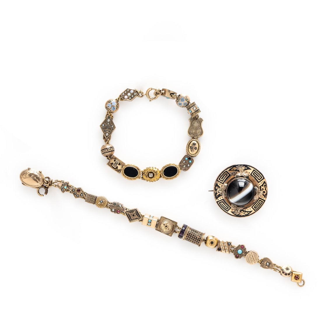 Two Low Karat Yellow Gold Slide Bracelets and a Mourning Brooch: Two Low Karat Yellow Gold Slide Bracelets and a Mourning Brooch Including a mourning brooch set with a round cabochon banded agate and black enamel with a hair element on the reverse, and two
