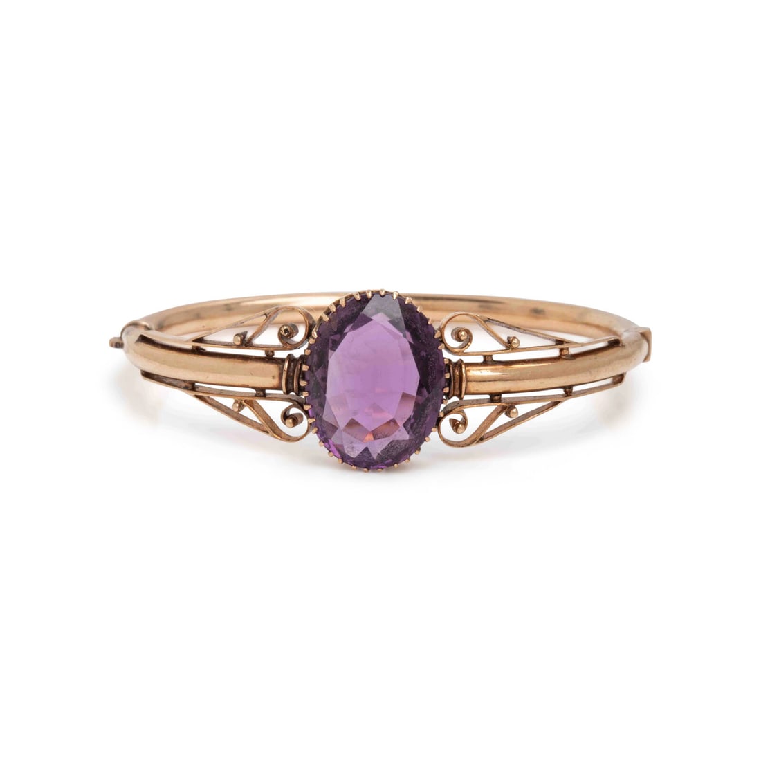 Amethyst and Yellow Gold Bangle Bracelet: Amethyst and Yellow Gold Bangle Bracelet Oval amethyst weighing approximately 10.85 carats by formula, hinged with a side clasp. Yellow gold. 6 inches inner circumference. Gross weight: 9.60 dwt. This