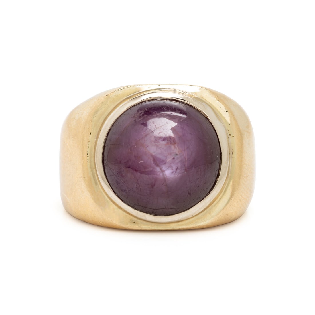 Yellow Gold and Star Purple Sapphire Ring: Yellow Gold and Star Purple Sapphire Ring Round cabochon star purple sapphire weighing approximately 19.00 carats by formula. 14 karat yellow gold. Ring size 8. Stamp: 14K STULLER (partially obscured)