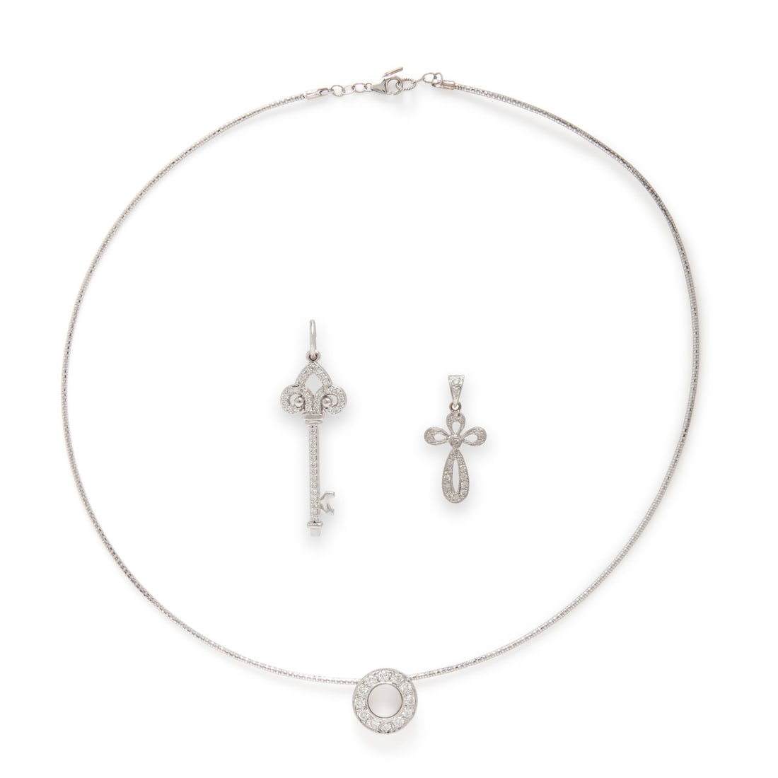 Collection of White Gold and Diamond Jewelry: Collection of White Gold and Diamond Jewelry Including a necklace with a slide pendant, a key pendant, and a cross pendant, each set with round diamonds. 14 and 18 karat white gold. Necklace: 17 1/2