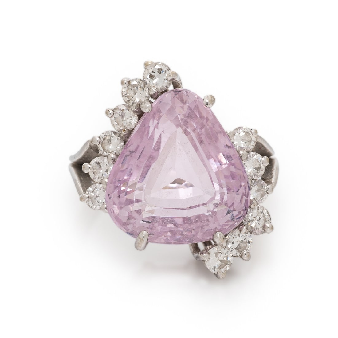 Kunzite, Diamond, and White Gold Ring: Kunzite, Diamond, and White Gold Ring Shield cut kunzite weighing approximately 14.00 carats by formula and round diamonds weighing approximately 0.80 carat total. 18 karat white gold. Ring size 6.