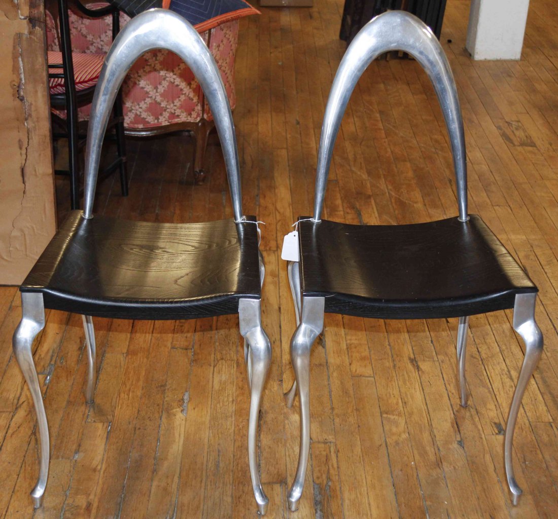 A Pair of Aluminum and Ebonized Wood Side Chairs,: A Pair of Aluminum and Ebonized Wood Side Chairs, each having an arched crest over the trapezoidal plank seat, raised on cabriole legs. Height 35 1/2 inches. Property from the Estate of Jeanne Marient