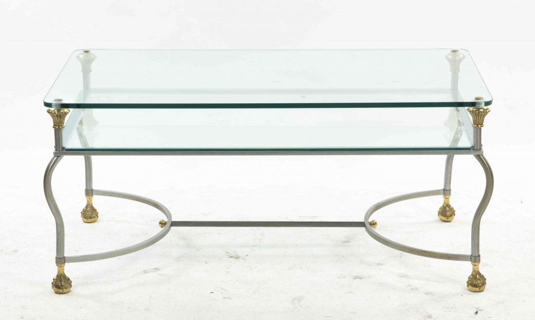A Brass, Glass and Chromed Low Table, Height 19 x width: A Brass, Glass and Chromed Low Table, having a rectangular top with rounded corners, raised on shaped legs joined by a medial shelf, ending in claw and ball feet. Height 19 x width 41 3/4 x depth 25 3