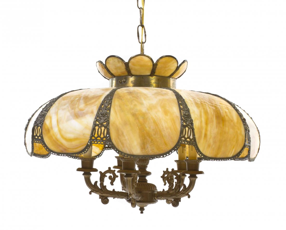 An American Cast Metal and Slag Glass Fixture, Diameter: An American Cast Metal and Slag Glass Fixture, of stylized flower form, having ten panels set with a four light gilt metal lighting element. Diameter 23 inches.