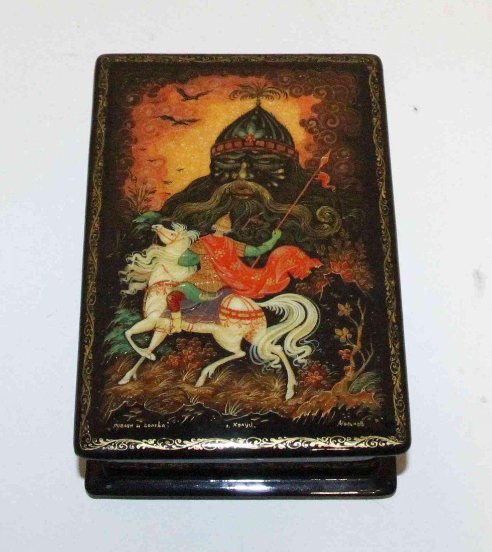 A Russian Lacquered Box, Height 5 1/2 inches.: A Russian Lacquered Box, having a rectangular hinged lid depicting a scene from Russian folklore, signed in Cyrillic. Height 5 1/2 inches. Property from the Estate of Jeanne Marienthal Westcott, Chica