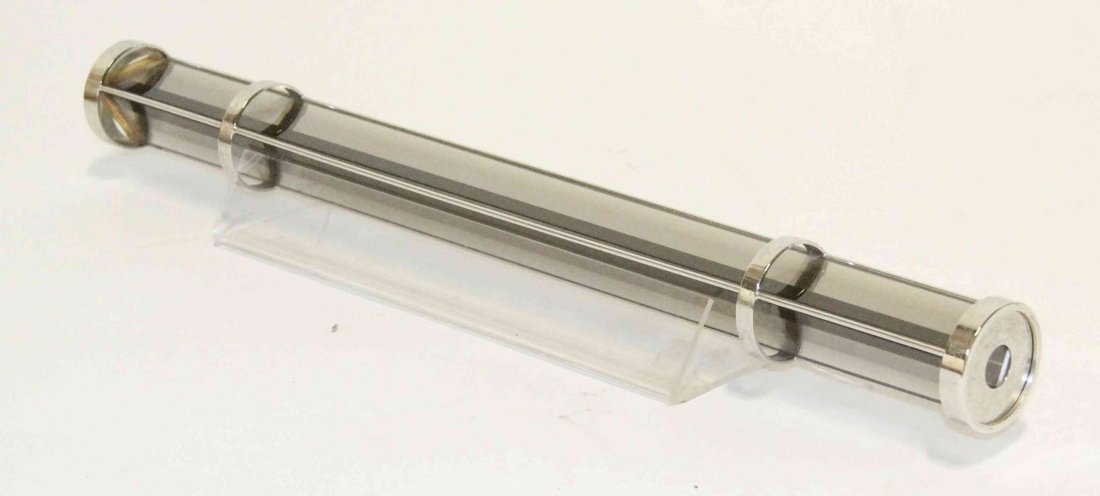 A Silvered Metal and Mirrored Kaleidoscope, Timothy: A Silvered Metal and Mirrored Kaleidoscope, Timothy Grannis and Jack Lazarowski, Light Machine, 1984, of elongated triangular form, signed Prism Design '84, with an acrylic stand. Length 18 1/2 inches