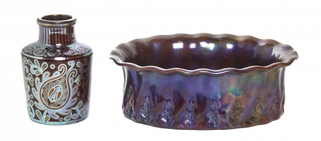 Two Zsolnay Pecs Iridescent Pottery Articles, Width of: Two Zsolnay Pecs Iridescent Pottery Articles, comprising an oval jardiniere with a flared rim and impressed repeating foliate decoration and a bottle form vase with silver stylized foliate decoration.