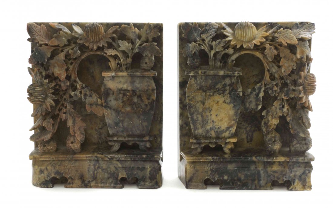 A Pair of Chinese Soapstone Bookends, Height 6 1/4: A Pair of Chinese Soapstone Bookends, each depicting opposing vases with floral arrangements on a carved plinth base. Height 6 1/4 inches.