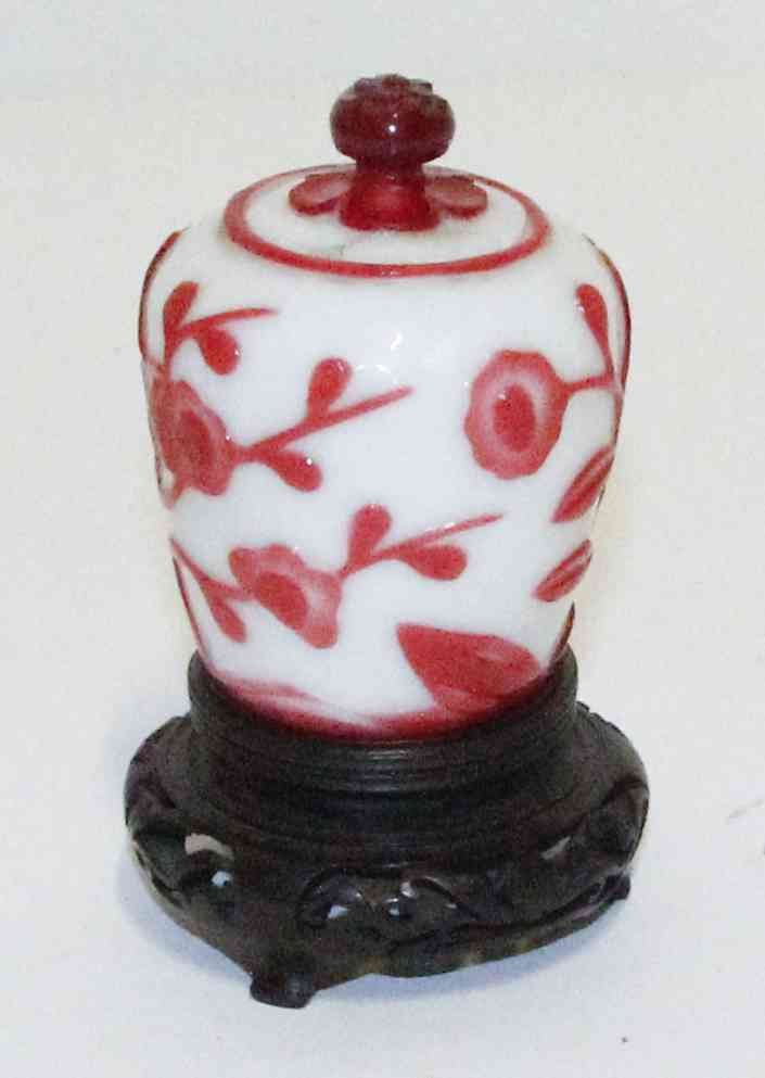 A Peking Glass Jar, Height 3 5/8 inches.: A Peking Glass Jar, with floral decoration, raised on a wood base. Height 3 5/8 inches. Property from the Estate of Jeanne Marienthal Westcott, Chicago, Illinois