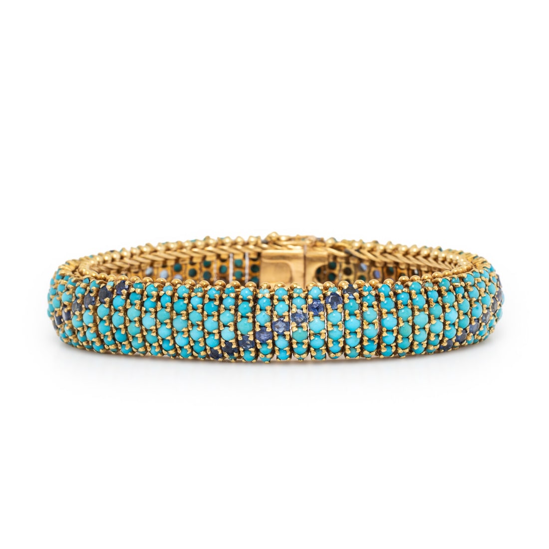 Turquoise and Sapphire Bracelet: Turquoise and Sapphire Bracelet Designed with round cabochon turquoise and round sapphires, set in flexible links. Mounted in yellow gold. 6 3/4 inches long. Gross weight: 46.40 dwt. Property from a P