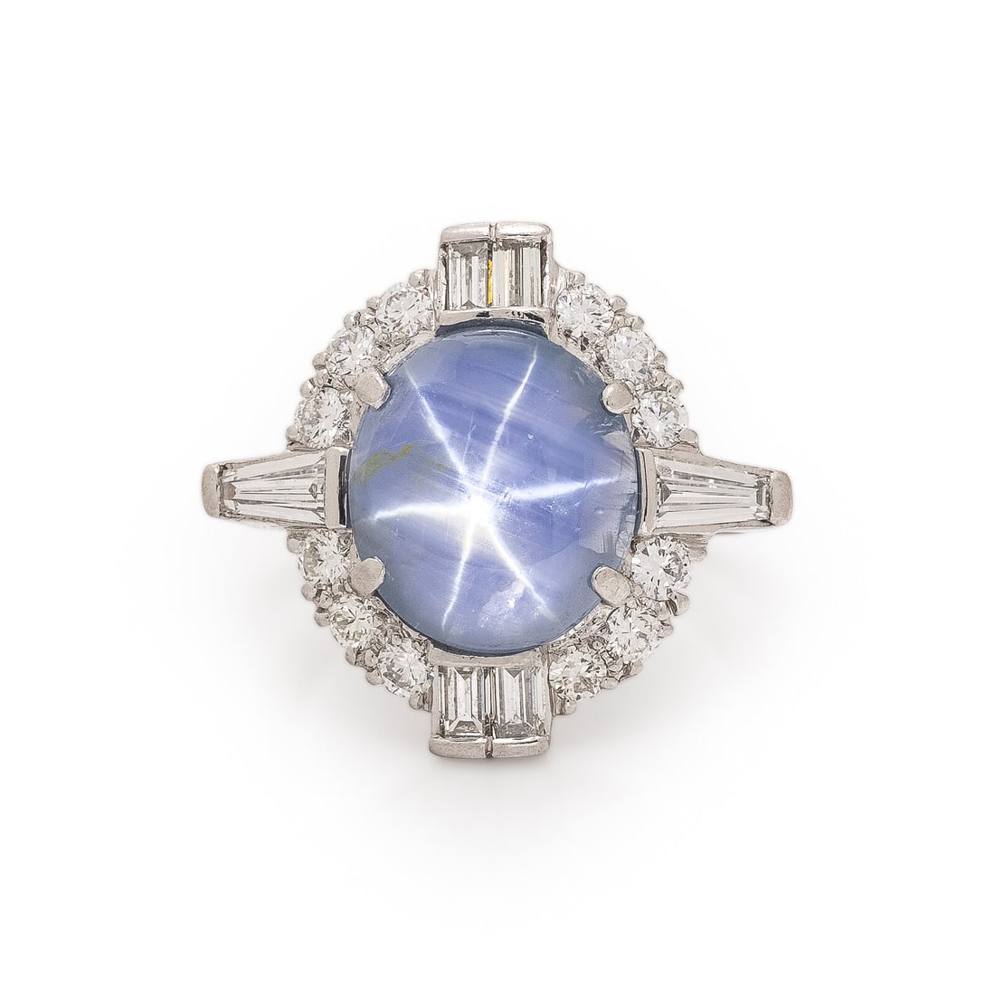 H.W. Beattie & Sons, Star Sapphire, Diamond, and Platinum Ring: H.W. Beattie & Sons, Star Sapphire, Diamond, and Platinum Ring Featuring an oval cabochon star sapphire weighing approximately 7.00 carats by formula, haloed by transitional, baguette, and tapered bag