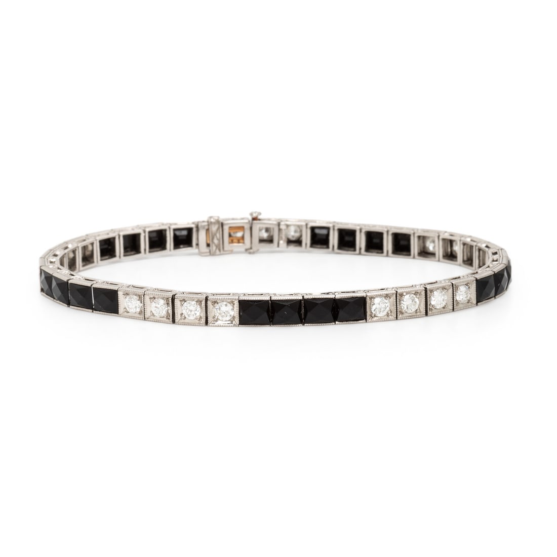 Art Deco, Onyx, Diamond, and Platinum Bracelet: Art Deco, Onyx, Diamond, and Platinum Bracelet Set with transitional cut diamonds weighing approximately 1.80 carats total and faceted black onyx, finished with milgrain edges. Mounted in platinum. 7 
